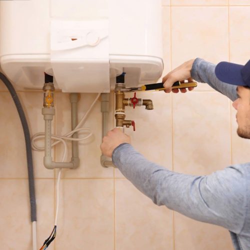 depositphotos_147562951-stock-photo-plumber-repairing-boiler-in-bathroom-transformed